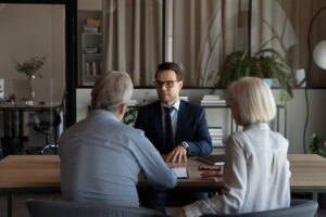 A selling away lawyer reviewing legal options with an elderly couple.