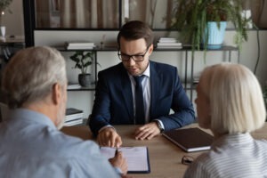 A FINRA arbitration attorney reviewing legal options with senior clients.
