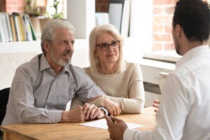 A FINRA arbitration lawyer in Louisiana reviewing legal options with senior