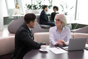 A financial advisor negligence lawyer meeting with a senior client and explaining what constitutes financial advisor/broker negligence.