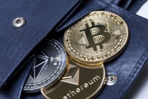 Wallet with cryptocurrency coins, with someone nearby wondering if Robinhood can recover their stolen crypto
