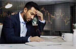 A businessman at his computer wonders how he can recover his investment losses